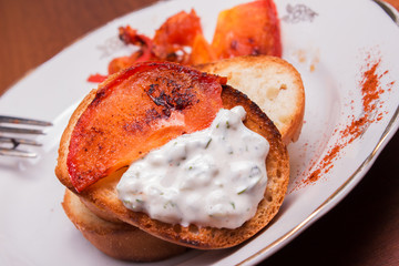 a slice of toasted bread crust with tomato sauce