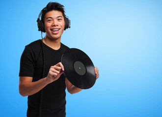 chinese man with headphones and vinyl