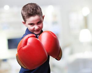 little kid fighting with red boxing gloves