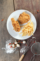 Fototapeta na wymiar fried chicken with french fries on wood table.