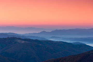 Fototapeta na wymiar Beautiful landscape at dawn. Layers of mountain in pink light.
