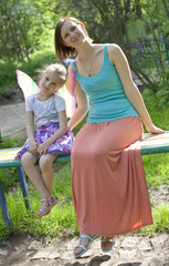 Naklejka premium Mummy and daughter, happy family in the park