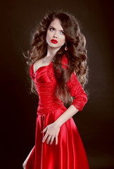 Beautiful Woman in red dress. Attractive fashion girl model with