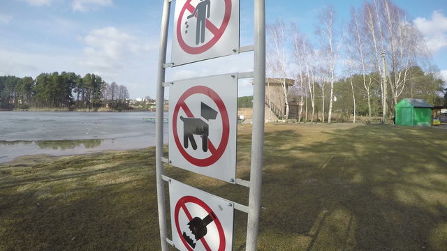 Prohibiting signs near lake. No dogs no alcohol no litter. 4K