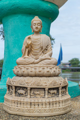 the ancient sitting white buddha statue  under sunlight