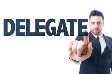 Business man pointing the text: Delegate