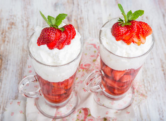 Strawberries in jelly topped with whipped cream