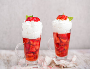 Strawberries in jelly topped with whipped cream
