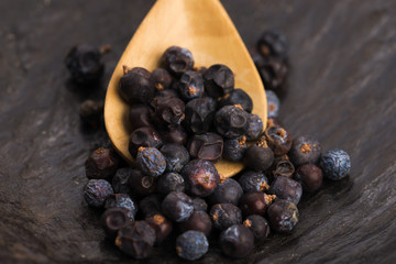 Juniper berries on a wooden background