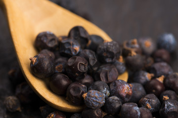 Juniper berries on a wooden background