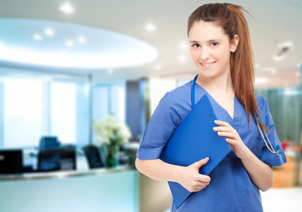 Smiling female doctor holding a clipboard