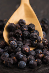 Juniper berries on a wooden background