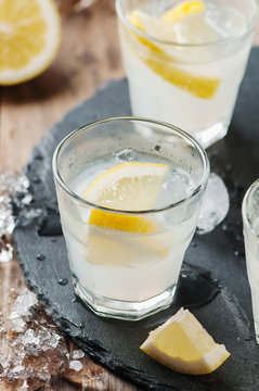 Homemade lemonade with lemon and ice