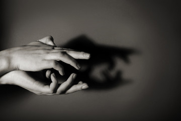 Hands gesture like crocodile on gray background