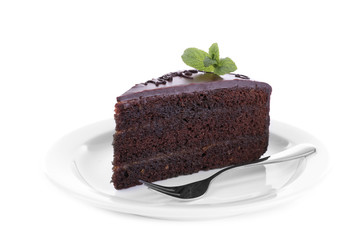 Piece of chocolate cake with mint isolated on white