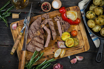 Medium rare grilled ribeye steak on cutting board