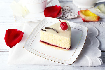 Tasty piece of cheesecake on plate on table close up