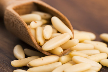 Dry Organic Pine Nuts on Wooden Background