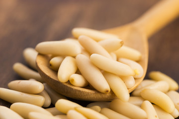 Dry Organic Pine Nuts on Wooden Background
