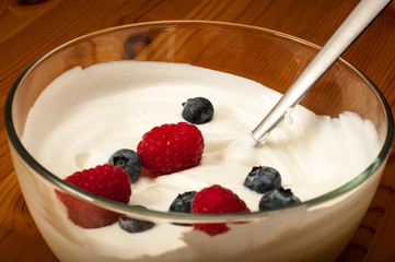 Bowl of yogurt with raspberries and blueberries