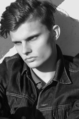 Obraz premium Stylish man sit in a denim jacket