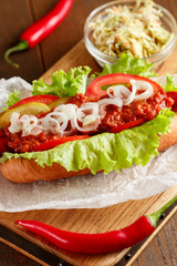 Hot-dog on wooden cutting board