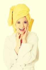 Young smiling woman in bathrobe