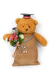 teddy bear toy clutching a flower in its arms