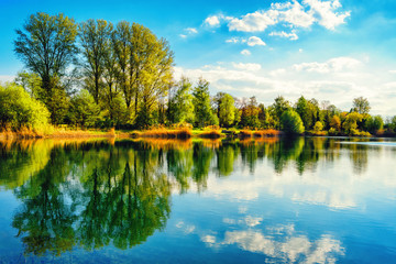 Tranquil lakeshore landscape with blue sky and water