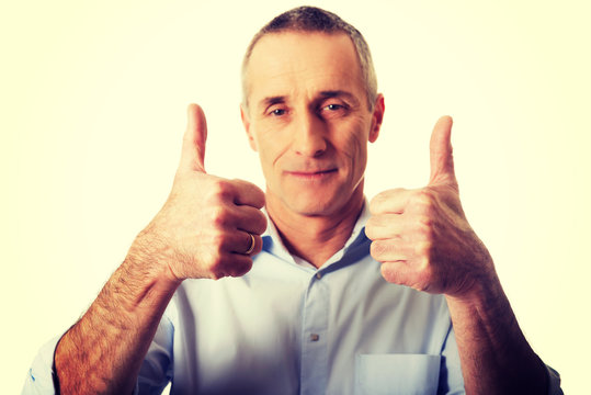 Portrait of mature man gesturing ok sign