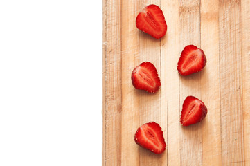 sliced strawberries on a wooden board