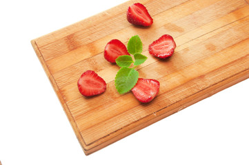 sliced strawberries on a wooden board