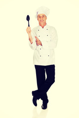 Chef holding black plastic spoon