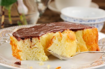 Homemade baked pudding with chololate icing, jsilver spoon and t