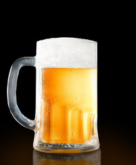 Mug of beer isolated on black