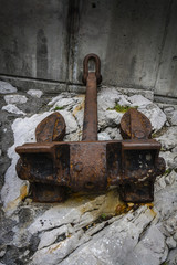 an anchor of an old rusty and secluded ship in a port

