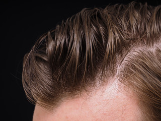 Hairstyle on male person with brown hair at closeup isolated tow