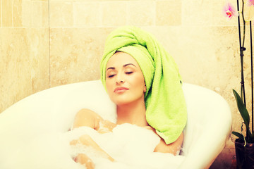 Woman relaxing in bath with eyes closed