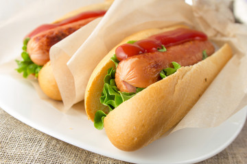 Hotdogs on white dish  wooden table