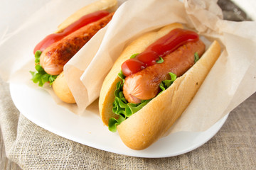Hotdogs on white dish  wooden table