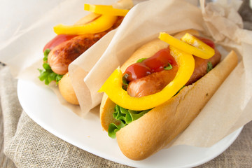 Hotdogs on white dish  wooden table