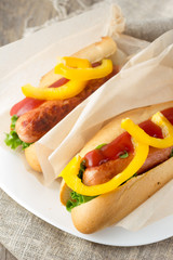 Hotdogs on white dish  wooden table