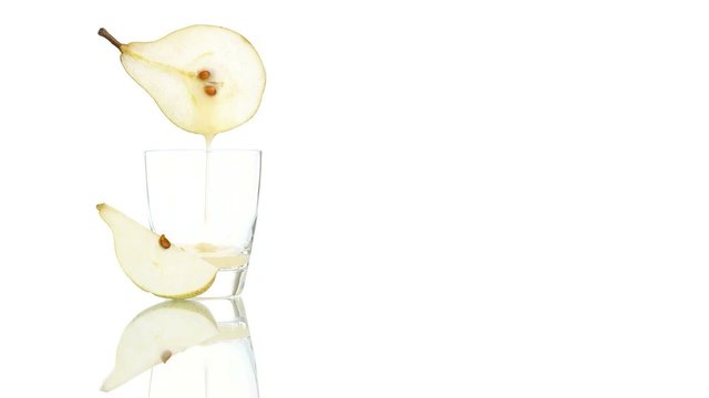 pear juice poured in to the glass isolated on white background
