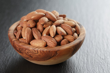 roasted almonds in bowl on slate background
