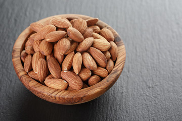 roasted almonds in bowl on slate background