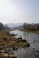 sunset on the mountain river flowing over rocks