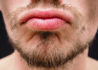 Hot male lips with untrimmed beard at closeup