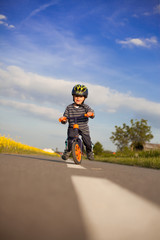 Obraz premium Little boy is learning to bike.
