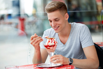 Teenager with a cup of ice cream in summer