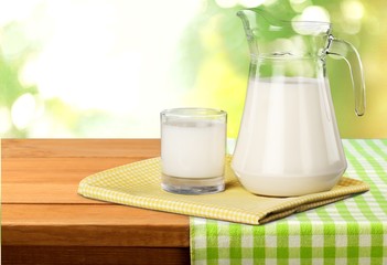 Milk, glass, tablecloth.
